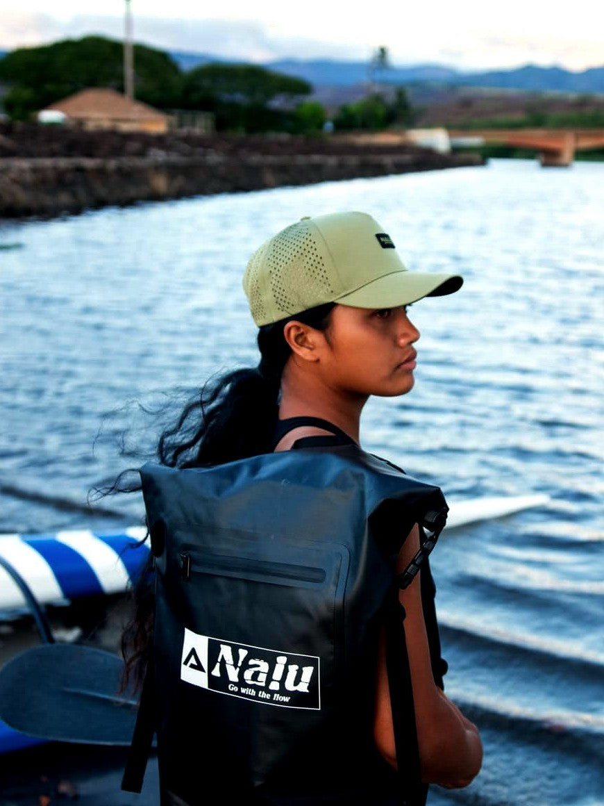 Nalu Black Dry Bag Backpack, worn by a paddler at the water