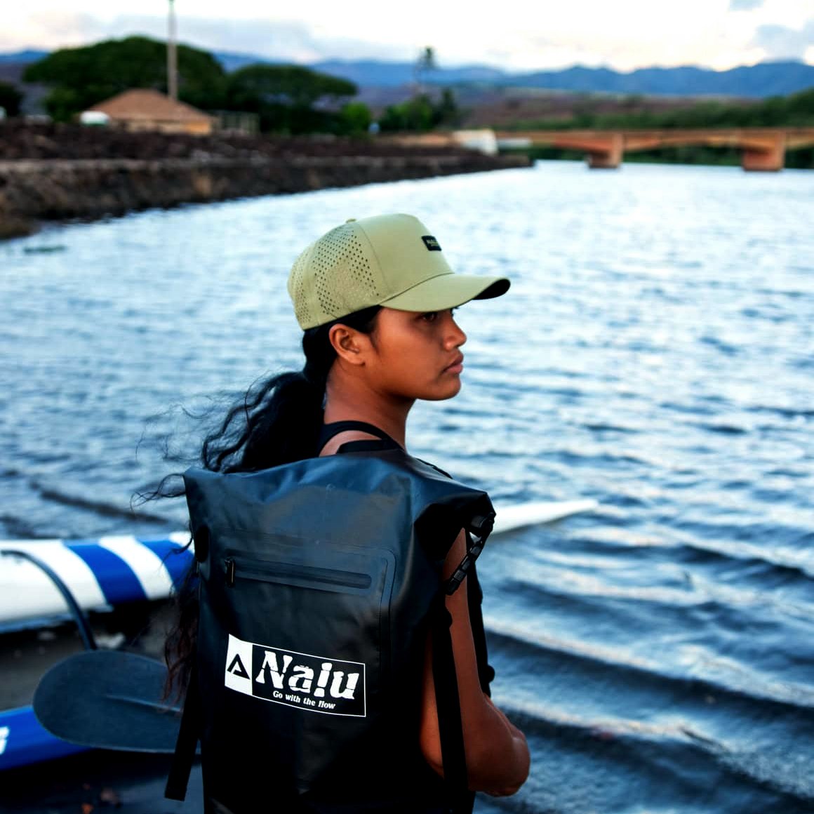 Nalu Black Dry Bag Backpack, worn by a paddler at the water