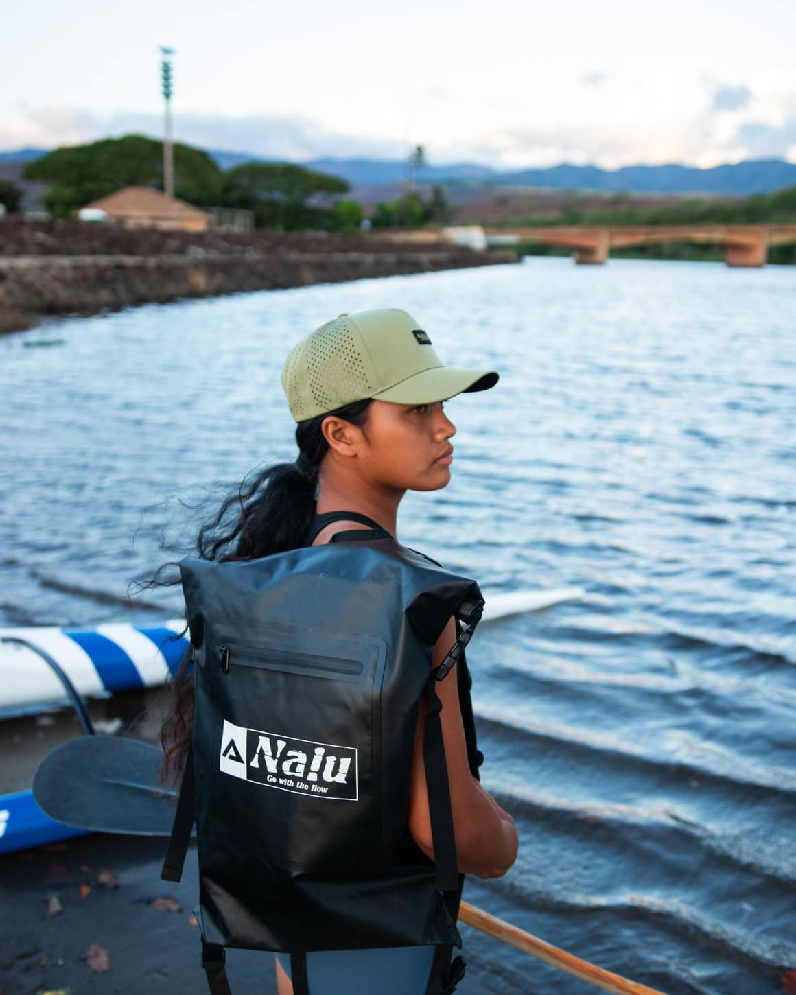 Nalu Black Dry Bag Backpack - Partially full and on woman's back | Nalu Gear