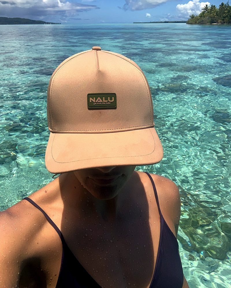 A Nalu hat worn over clear reef water